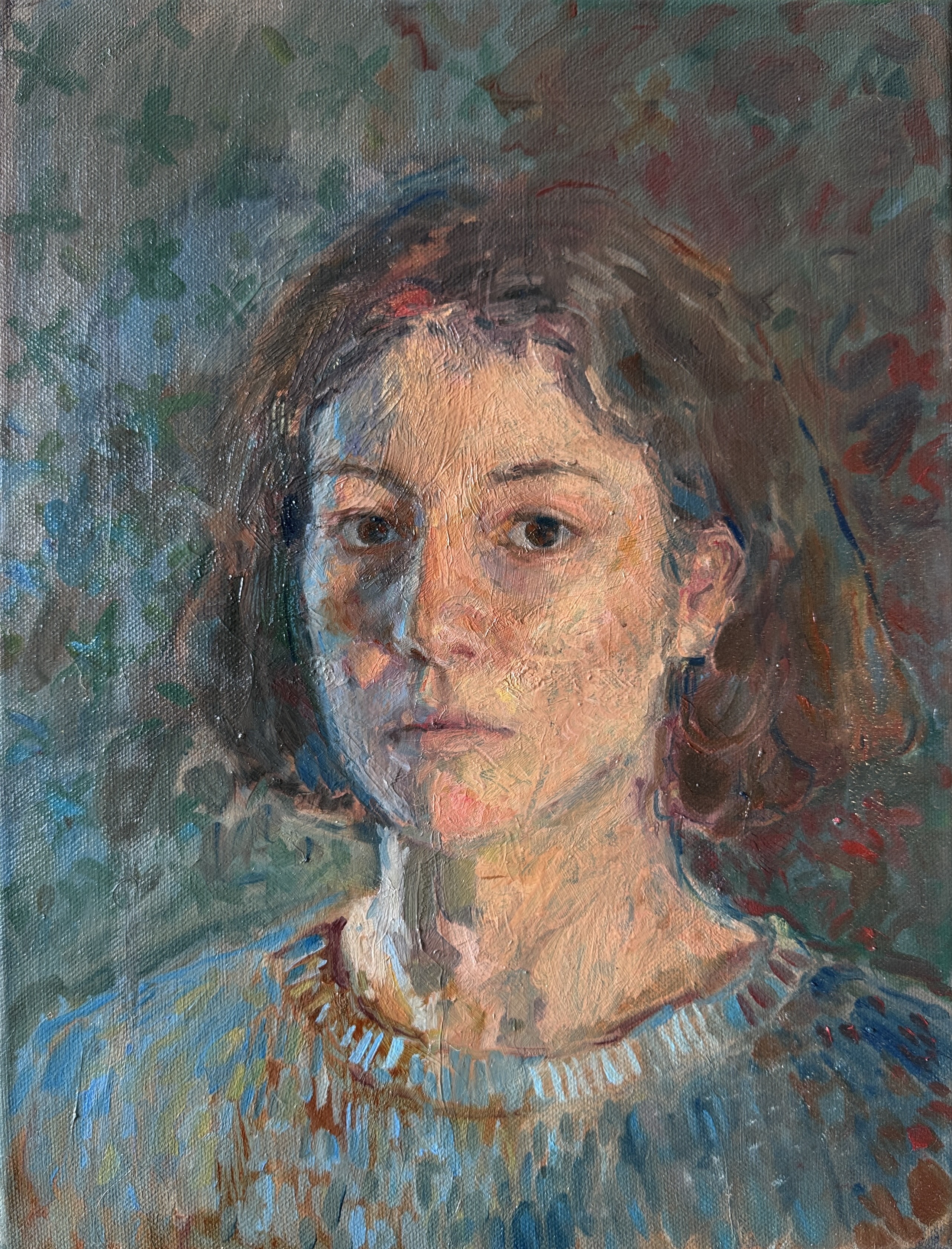 A woman looks directly at viewer.